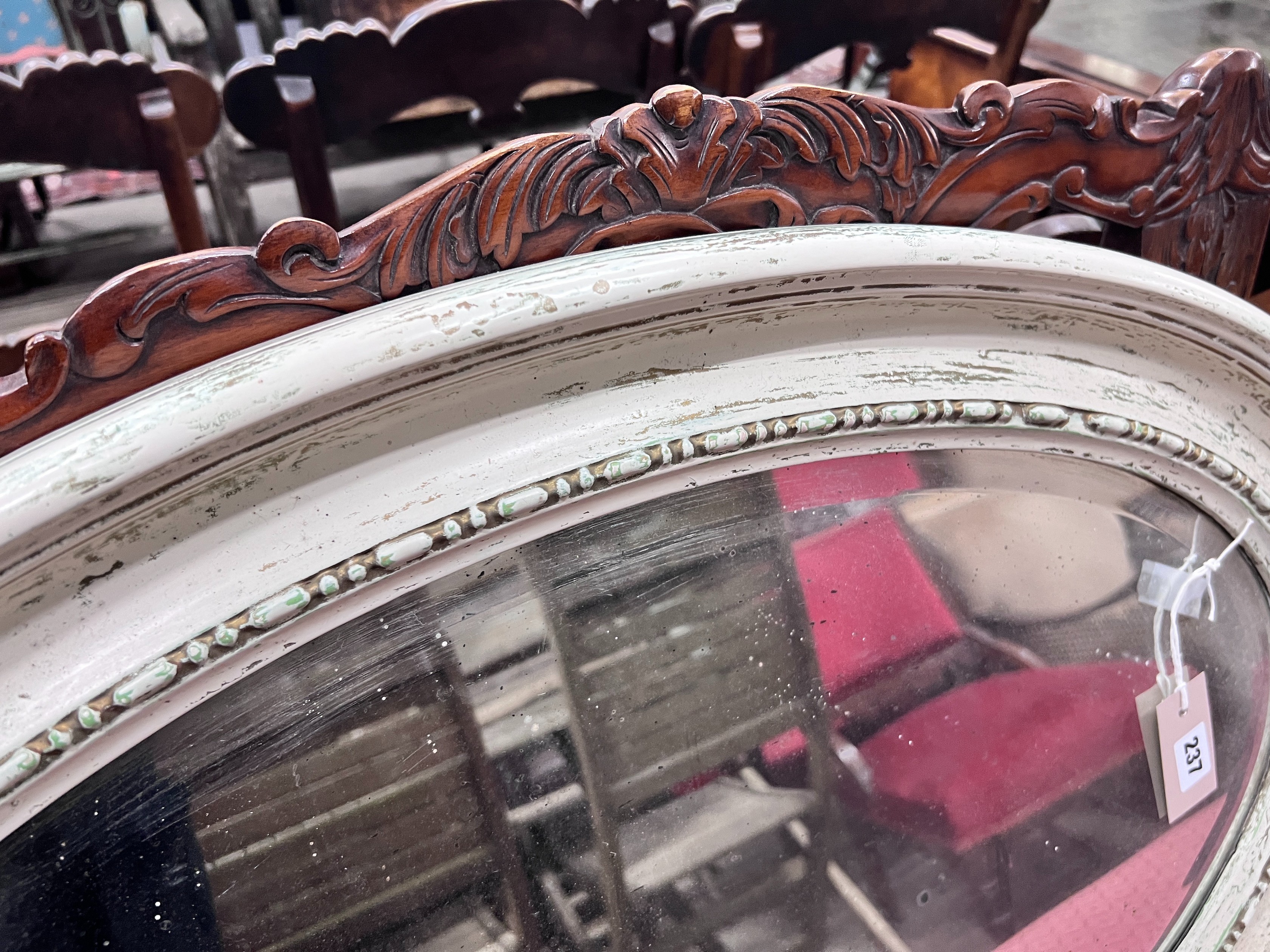 A 1920's white gesso framed oval wall mirror, 84cm *Please note the sale commences at 9am.